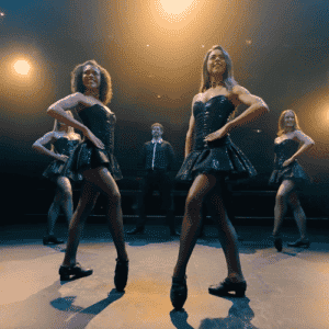 Irish dance troupe on stage featuring two females and two males in the classic Irish dancing stance